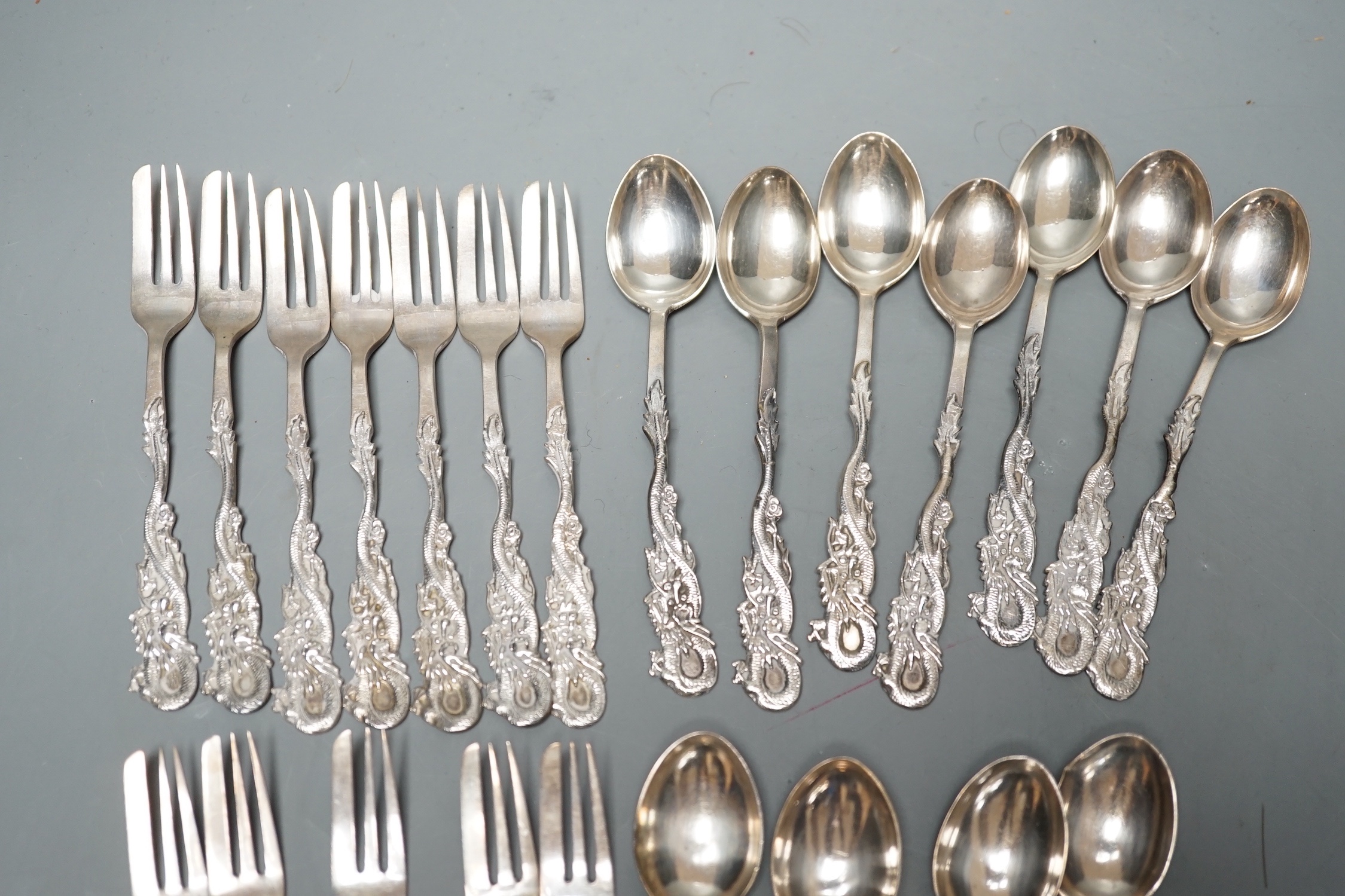 A set of twelve Chinese sterling tea forks, with dragon handles by YCCo and eleven similar teaspoons, 8oz.